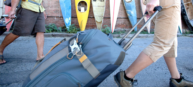 Person pulling suitcase on wheels