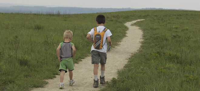 Two children traveling on a walking trail in manhattan ks