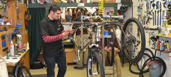 Person repairing bike in shop